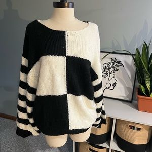 Vintage look black and white colorblock sweater with billowy sleeves.